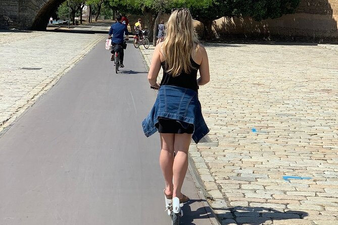 Electric Scooter Rental Seville - Crossing Triana Bridge into a different Seville