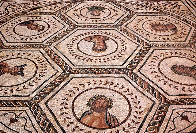 From Seville: Italica Roman City & Medieval Monastery Tour - Entering Italica and its enormous amphitheater