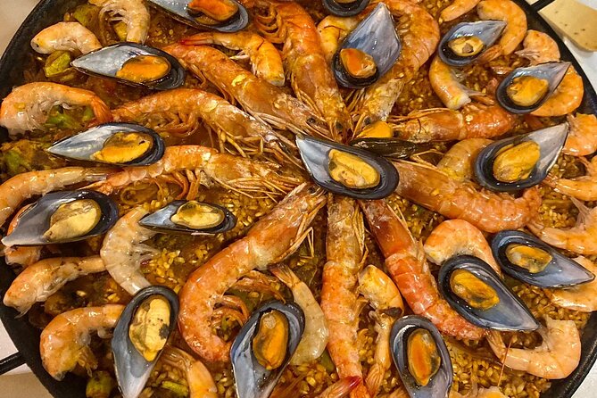 Sangria Tasting & Paella Showcooking Experience - A rooftop food experience with a clear Seville setting