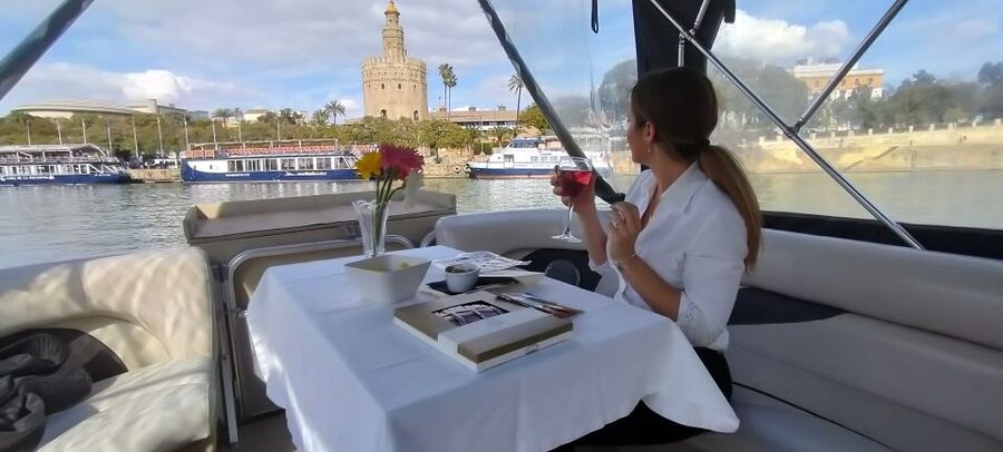 Seville: Exclusive River Boat Tour with Tapas - Passing beneath Triana Bridge
