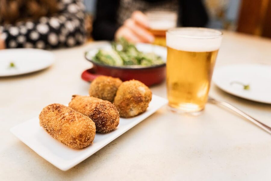 Seville Food Tour with Tapas & Drinks with a Local - First stops: ham, cheese, and Seville’s small-plate customs