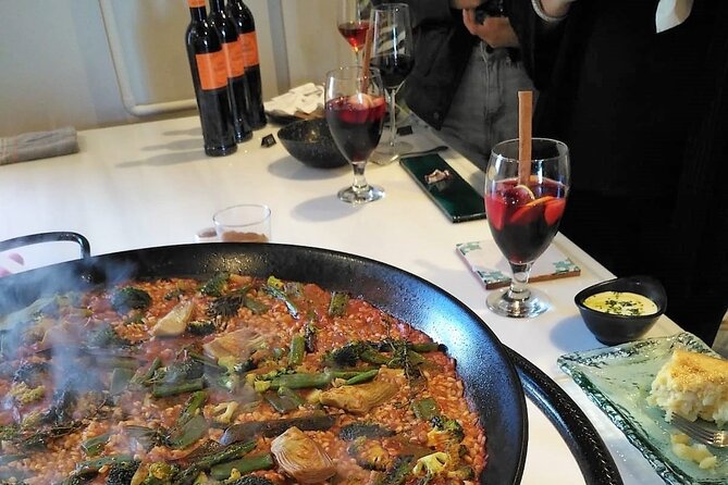 Seville: Rooftop Paella Showcooking and Sangría - Local bites while the pan does its work